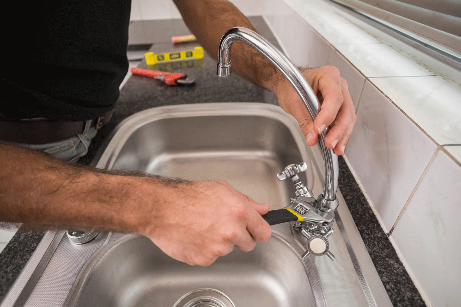 Kitchen tap being fitted, plumbing work carried out by James Plumbing and Heating